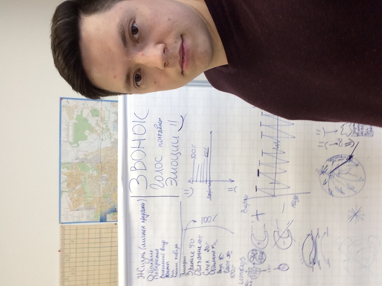 Robert Ivanov beside a board with working notes